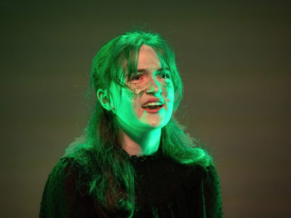 student on stage for wicked